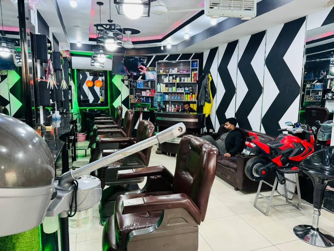 Inside Ahmad Hair Dresser, with barber chairs and a black and white chevron floor